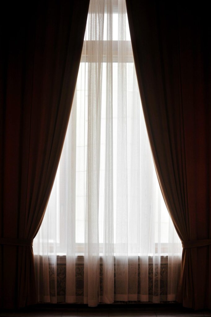 Blackout curtains. Big velvet window curtain shot against outdoor light