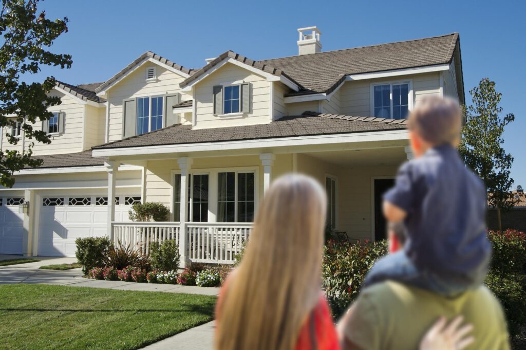 First-time homebuyers - a Young Family Looking at a Beautiful New Home.