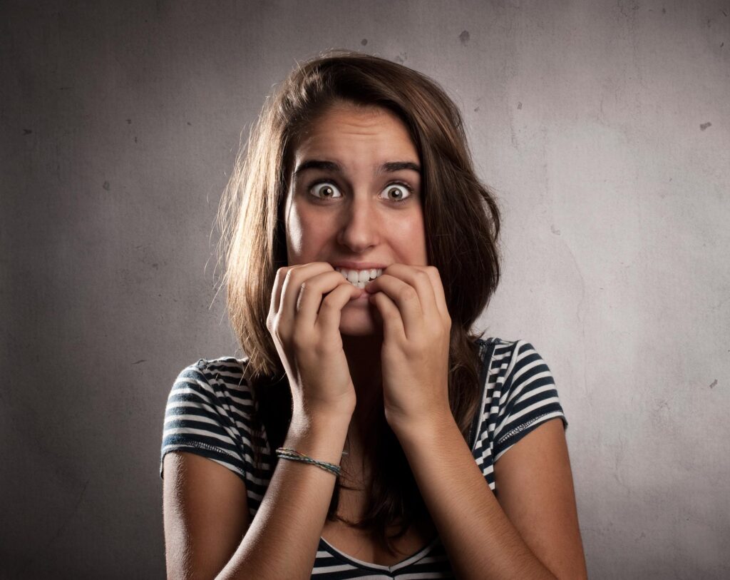 portrait of young woman scared after making an offer on a home