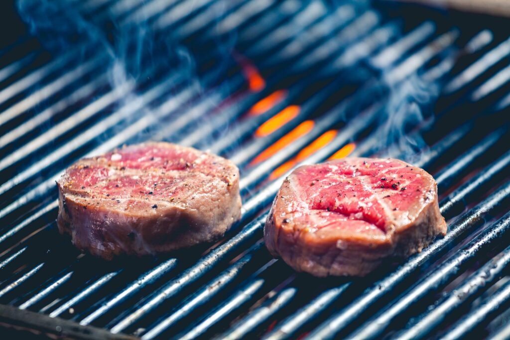 Portable grills with steaks on the grill