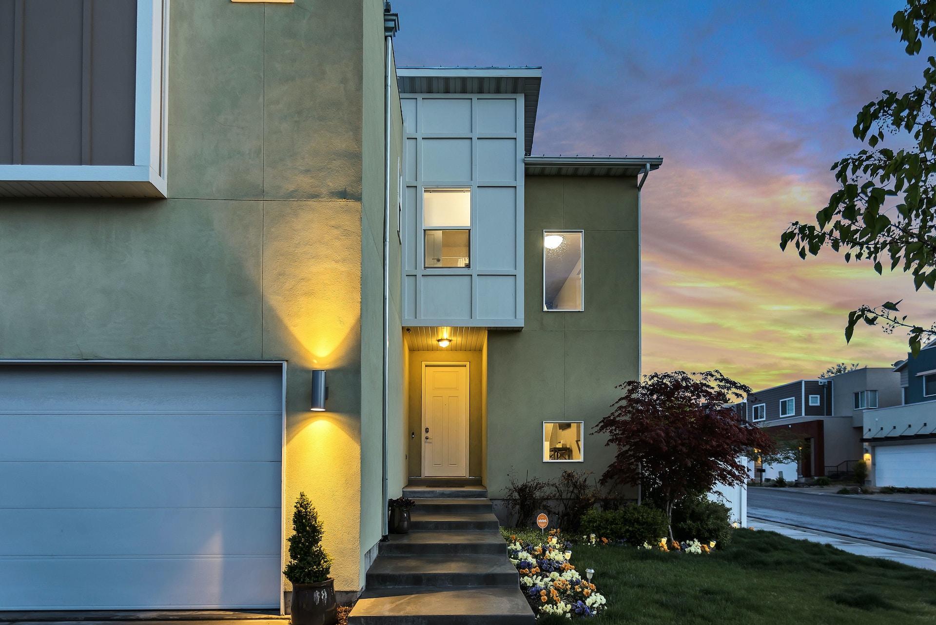 Beautiful home at dusk with accent lights and sunset sky