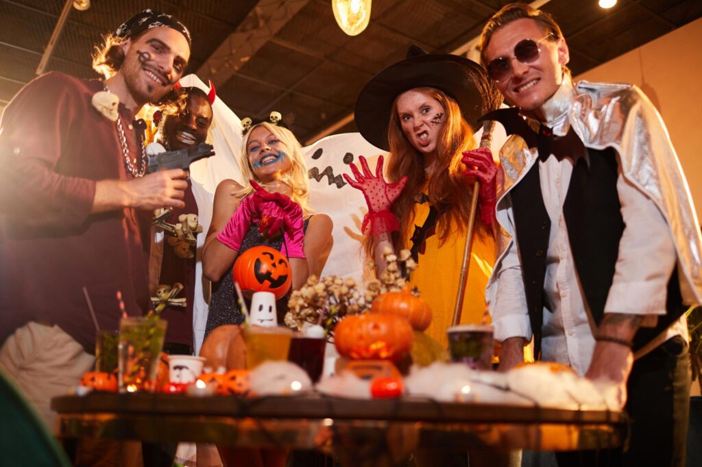 adults enjoying a Halloween party dressed in costumes